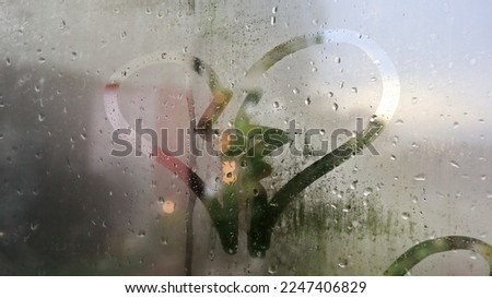 the sign of a broken heart on the dewy glass