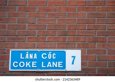 Sign Coke Lane 7 In Irish And English Language On A Street In Dublin City, Ireland. Copy Space. Slang Word For Highly Expensive Drug Cocaine.