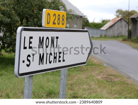 sign with directions to Mont Saint Michel where there is the Ancient Abbey on the hill in northern France