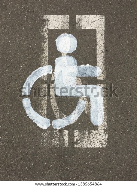 The sign the disabled person drawn on the parking.\
New from above old.