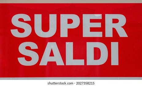 Sign Displayed On A Shop Window That Reads Super Sales