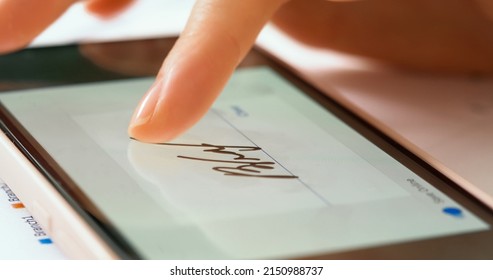Sign document of deal on digital gadget. Digital signature on smartphone screen with woman hand. Close up.