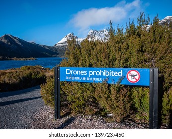 Sign of Drones Prohibited written in English and Chinese at Dove Lake in Cradle Mountain. Use of drones on reserved land is not permitted in Tasmania's national parks and reserves.