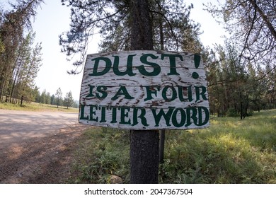 Sign - Dust Is A Four Letter Word Along A Dirt Word To Prevent Motorists From Kicking Up Dust With Cars