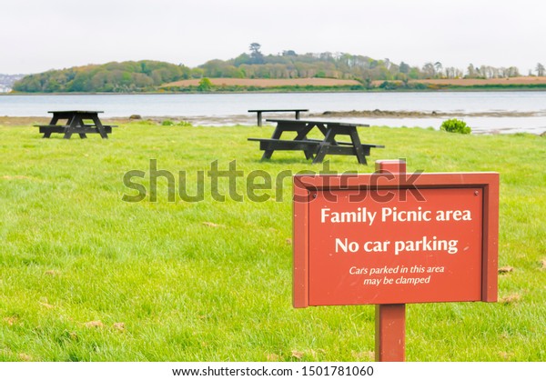 Sign at a family Picnic area warning that\
cars will be clamped if parked in this\
area