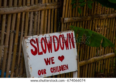Sign at the fence Slowdown we love our children in the Philippines. Pandan, Panay island