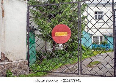A sign forbidding entry into the courtyard hangs on a metal gate - Shutterstock ID 2162779941
