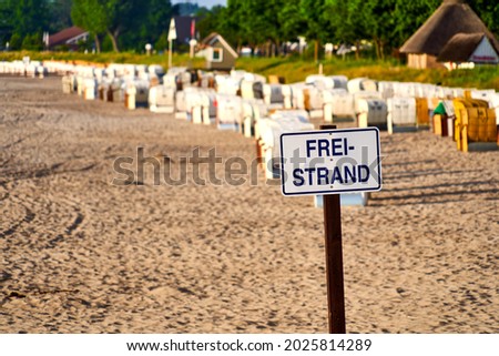 Sign for the free beach, which can be used without charge, German text on the sign means free beach