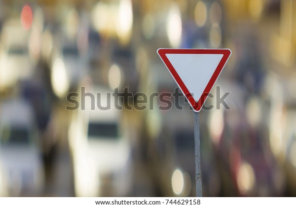 sign give way on\
the background of the car.