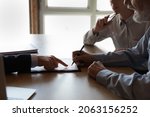 Sign here please. Close up of lawyer manager in formal attire show retired couple customers place to sign insurance contract bank deposit agreement. Senior spouses clients close deal in realtor office