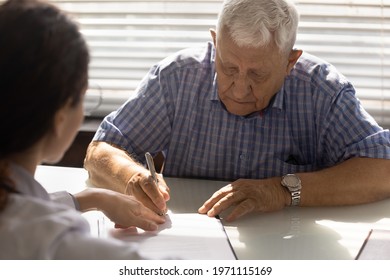 Sign here please. Sick elderly male affirming treatment plan by personal signature on appointment with doctor. Retired man patient sign contract on provision of health care service at physician office - Shutterstock ID 1971115169