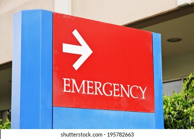 Sign At The Hospital Points Towards The Emergency Room Entrance.