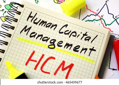 Sign Human Capital Management HCM On A Page Of Notebook.