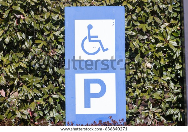 Sign indicates reserved area for people with\
disabilities at the parking\
lot
