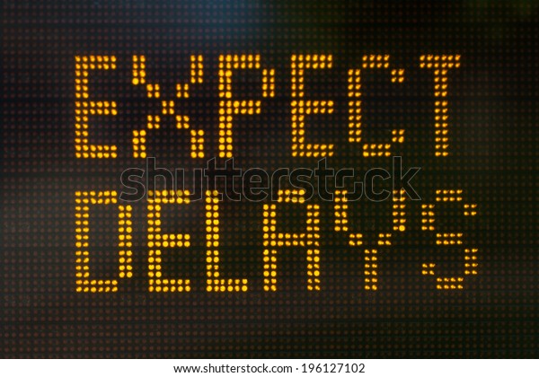 A sign\
informing motorists to expect\
delays