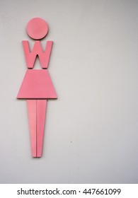 The Sign For Ladies Lavatory Women's Bathroom On Cement In A Public Building Business Place.