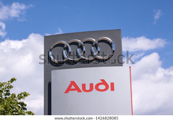 Sign with the logo of Audi AG. German automobile\
manufacturer. Audi is a member of the Volkswagen Group and has its\
roots at Ingolstadt, Bavaria, Germany. Copenhagen, Denmark - June\
17, 2019