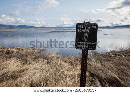 A sign at the Lower Klamath Wildlife Refuge in Siskiyou County California advises hunters that an area is open only to retrievals and they must unload firearms to enter
