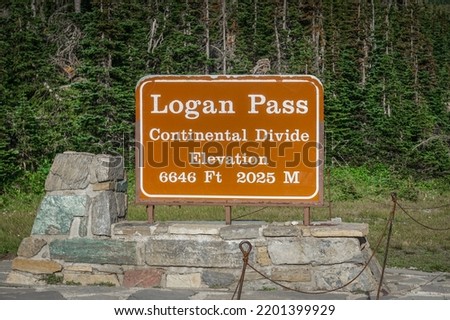 Sign marking Logan Pass and the Continental Divide in Glacier National Park, Montana.