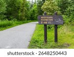 A sign marking the trail to the Mississippi Headwaters, guiding visitors to the source of this iconic river.