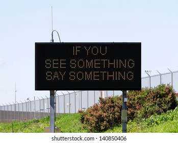 A Sign Near A Major Airport Urges Citizens To Report Suspicious Activity.