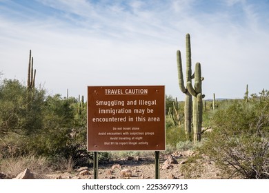 Sign near US - Mexican border wall reading Caution smuggling and illegal immigration in this area - Arizona