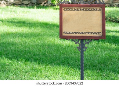 A Sign On The Background Of A Green Lawn