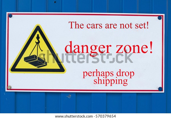 sign on
the blue wall, Danger Zone! cars do not
put!