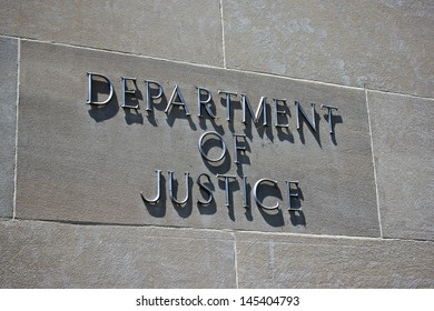 Sign on the exterior identifies the Department of Justice.