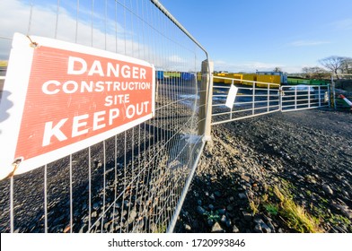 Sign on the fence of a construction site warning people to keep out