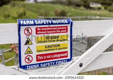 Sign on a field gate warning people not to enter farmland due to danger to life from livestock, and risk of bio-security breech.