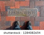 A sign on the ground labels Bethesda Avenue, a popular street for shopping and restaurants in the Chevy Chase neighborhood in Montgomery County. 