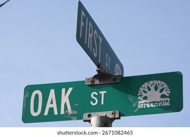 Sign on the intersection or corner of First street and Oak street in Greenville