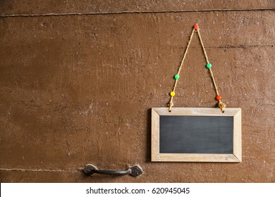 Sign On A Small Chalkboard Hanged To A Wood Door With Pins