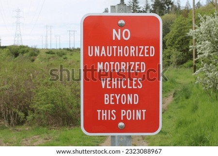 sign on walking path forbidding motorized vehicles
