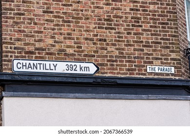 Sign on a wall in Epsom town centre, UK, which  twinned with  a French town Chantilly, 392 km away.