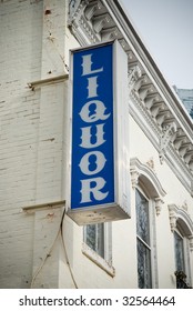 Sign Outside Of Liquor Store In Old Building.