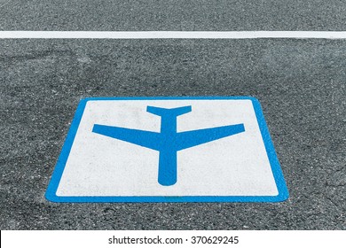 sign painted on asphalt road for airport shuttle bus