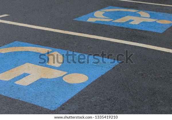 sign parking\
for disabled on asphalt,\
close-up