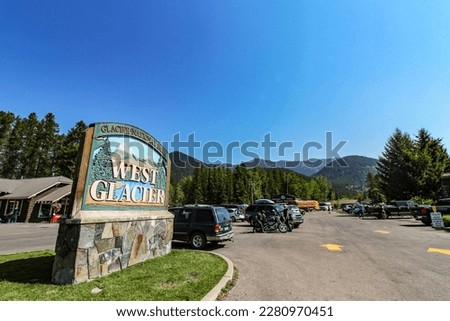 The sign and parking lot at the West Entrance to Glacier National Park in North Montana.