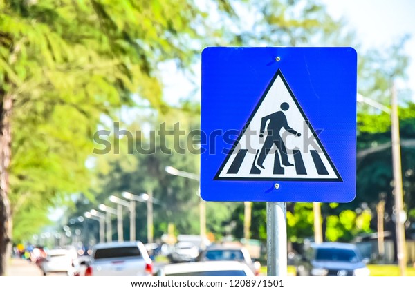 A sign for people crossing\
the street. On the coastal road. Of Songkhla Province,\
Thailand.