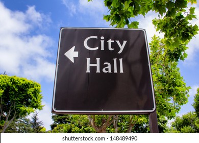 Sign Pointing In Direction Of City Hall