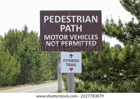 A sign pointing to the fitness trail and says 