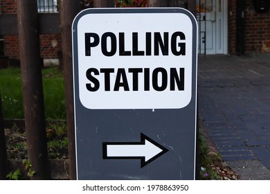 Sign points to the entrance of a polling station during the local elections in England in May 2021