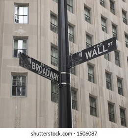 Sign post between broadway and wall street