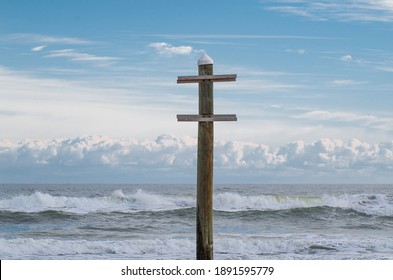 Sign post on the ocean shore