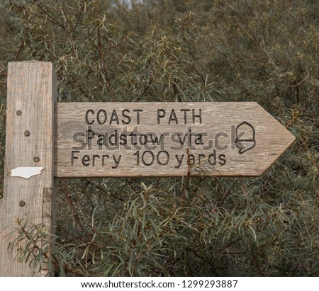 Sign Post to Padstow via Ferry and Way Marker for the South West Coast Path on the Camel Estuary at Rock, in Rural Cornwall, England, UK