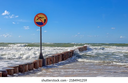 A sign prohibiting swimming on the breakwater - Shutterstock ID 2184941259
