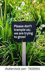 Sign in a public park instructing visitors not to trample plants.