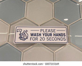 A Sign In A Public Restroom That Tells People To Please Wash Your Hands For 20 Seconds Due To The Coronavirus Pandemic.